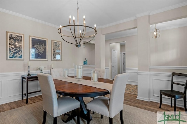 21 Shoefstall St, Savannah, GA 31407 - dining space with a decorative wall, wood finished floors, and a chandelier