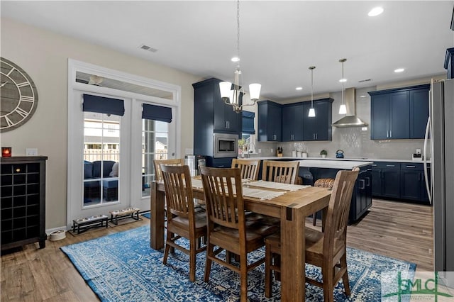 21 Shoefstall St, Savannah, GA 31407 - dining area with visible vents, baseboards, recessed lighting, light wood-style flooring, and a notable chandelier