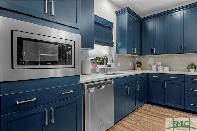 21 Shoefstall St, Savannah, GA 31407 - kitchen with light countertops, a sink, appliances with stainless steel finishes, and blue cabinetry