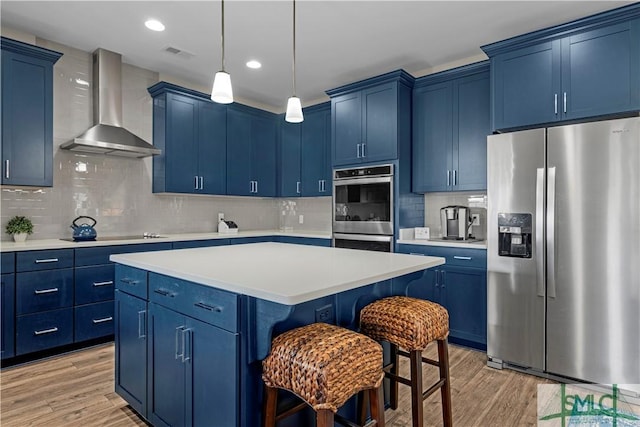 21 Shoefstall St, Savannah, GA 31407 - kitchen featuring stainless steel appliances, blue cabinets, and wall chimney exhaust hood