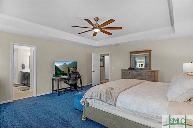 21 Shoefstall St, Savannah, GA 31407 - bedroom with a ceiling fan, baseboards, connected bathroom, a tray ceiling, and carpet flooring