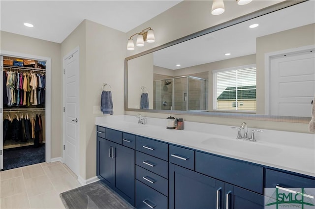 21 Shoefstall St, Savannah, GA 31407 - full bath featuring double vanity, a walk in closet, a stall shower, a sink, and baseboards