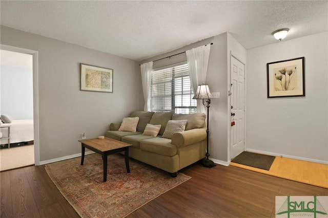 401 N Cromwell Rd Unit P-5, Savannah, GA 31410 - living area with dark wood-style flooring, a textured ceiling, and baseboards