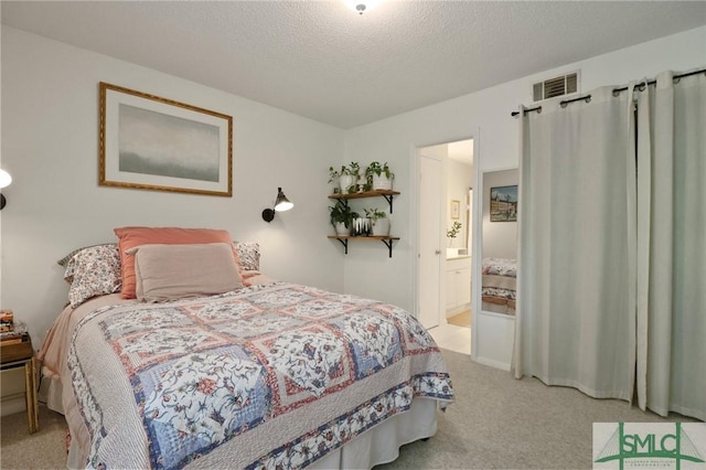 401 N Cromwell Rd Unit P-5, Savannah, GA 31410 - carpeted bedroom with a textured ceiling, visible vents, and ensuite bath