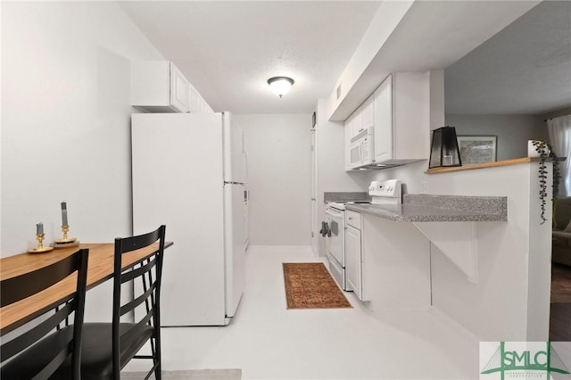 401 N Cromwell Rd Unit P-5, Savannah, GA 31410 - kitchen with baseboards, white appliances, and white cabinetry