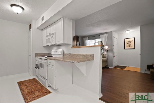 401 N Cromwell Rd Unit P-5, Savannah, GA 31410 - kitchen with visible vents, white appliances, a textured ceiling, white cabinetry, and light wood finished floors