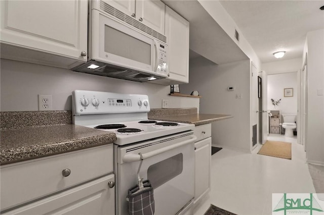 401 N Cromwell Rd Unit P-5, Savannah, GA 31410 - kitchen featuring white appliances, white cabinetry, dark countertops, and visible vents