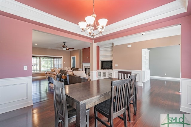 23 Olde Gate Ct, Pooler, GA 31322 - dining space with a wainscoted wall, a fireplace, ceiling fan with notable chandelier, and dark wood-type flooring