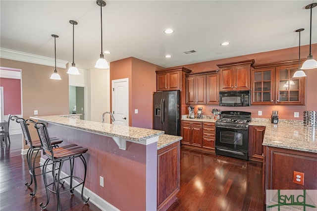 23 Olde Gate Ct, Pooler, GA 31322 - kitchen with glass insert cabinets, a breakfast bar area, dark wood-type flooring, brown cabinets, and black appliances