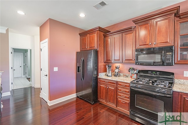 23 Olde Gate Ct, Pooler, GA 31322 - kitchen featuring black appliances, dark wood finished floors, light stone counters, brown cabinetry, and baseboards