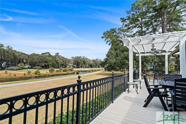 deck featuring a yard, a pergola, and a water view