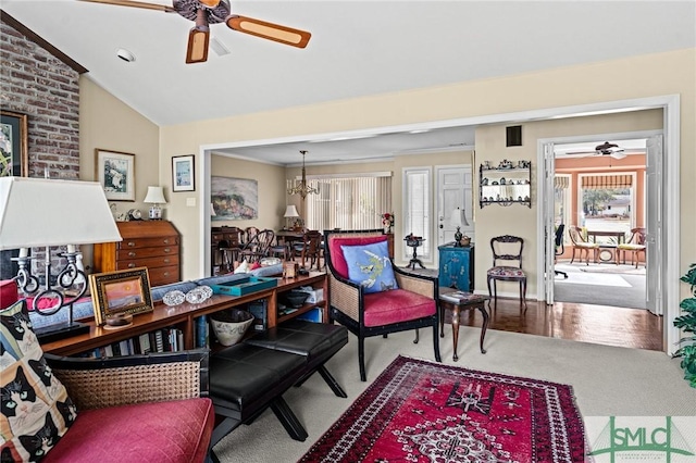 interior space featuring plenty of natural light, a ceiling fan, carpet flooring, and vaulted ceiling