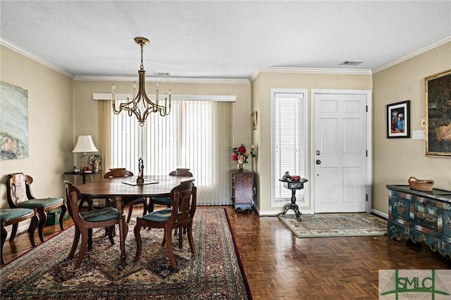 dining room with crown molding, baseboards, visible vents, and a notable chandelier