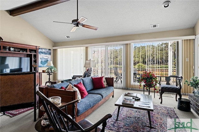 carpeted living area featuring visible vents, lofted ceiling with beams, and ceiling fan
