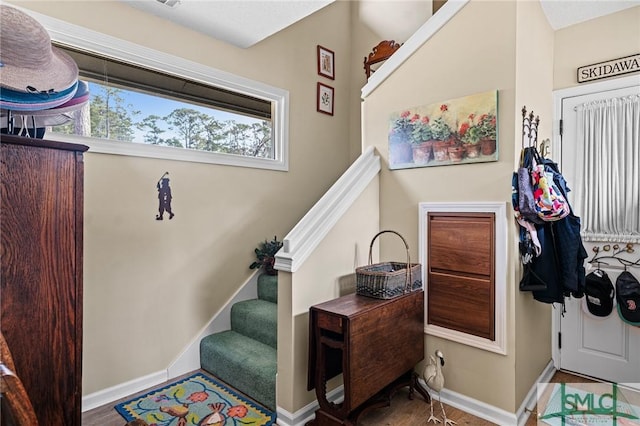 stairs featuring baseboards and wood finished floors
