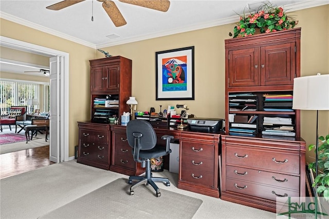office space with crown molding, a ceiling fan, and light colored carpet