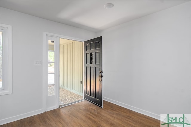 entryway with baseboards and wood finished floors