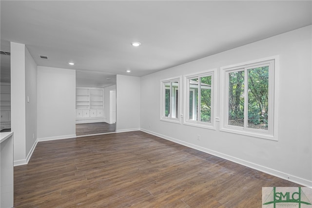 unfurnished room featuring recessed lighting, baseboards, visible vents, and dark wood finished floors