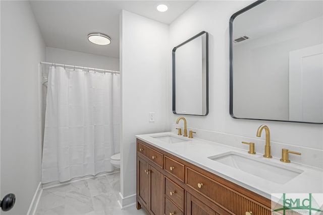full bathroom featuring visible vents, a sink, marble finish floor, and toilet
