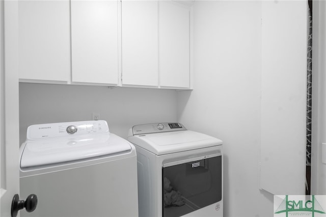 laundry room with cabinet space and washer and clothes dryer