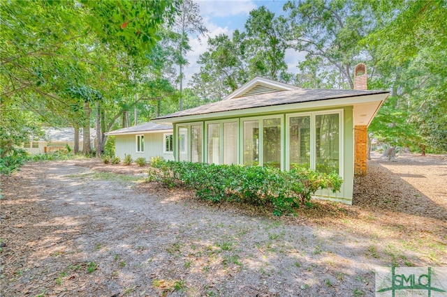 view of property exterior with a chimney