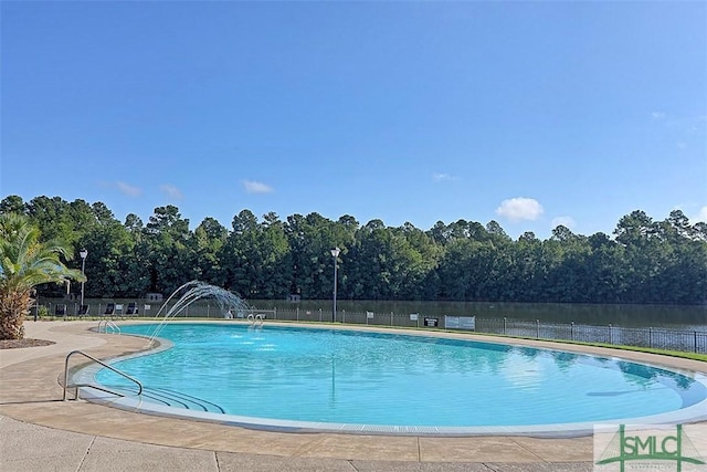 community pool featuring a patio and fence