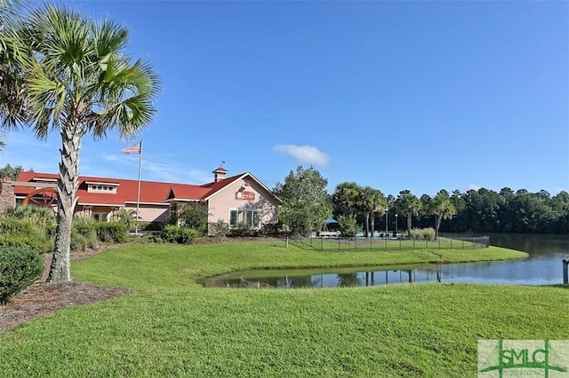 view of community with a lawn and a water view