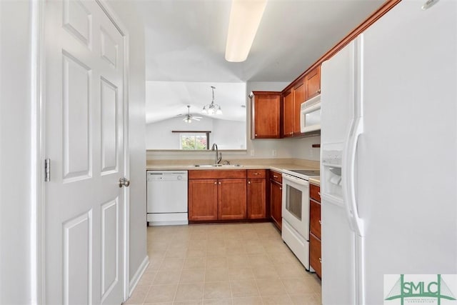 kitchen featuring white appliances, brown cabinetry, a sink, and light countertops