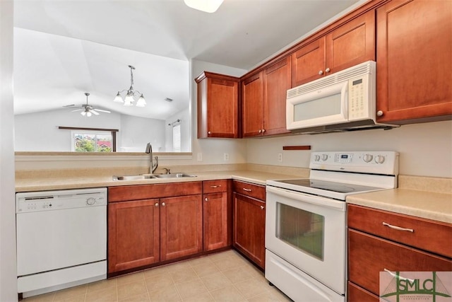 kitchen featuring brown cabinetry, lofted ceiling, white appliances, light countertops, and a sink