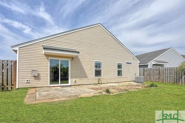 back of property featuring fence, a lawn, central AC, and a patio area
