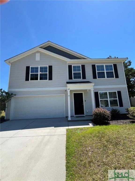 traditional-style home with an attached garage, concrete driveway, and a front lawn