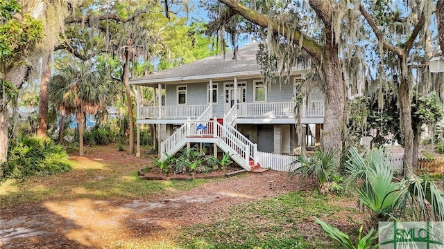 view of front of property with a porch and stairs