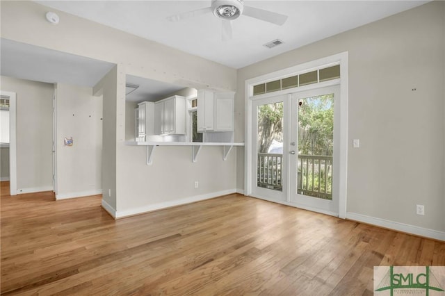 unfurnished living room featuring ceiling fan, light wood finished floors, french doors, baseboards, and visible vents