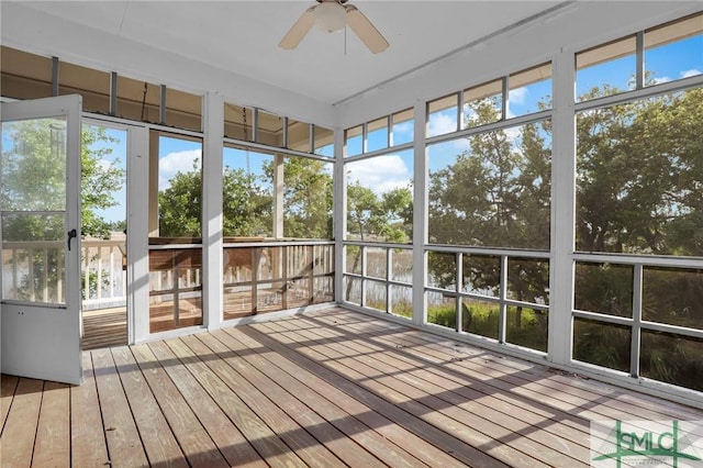 unfurnished sunroom featuring ceiling fan