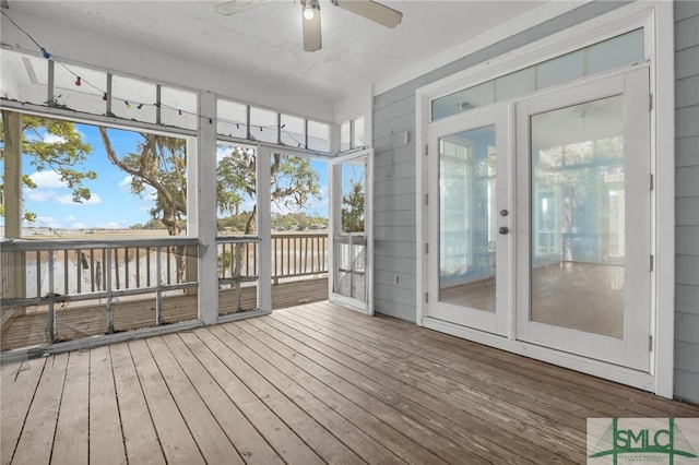 unfurnished sunroom with a ceiling fan