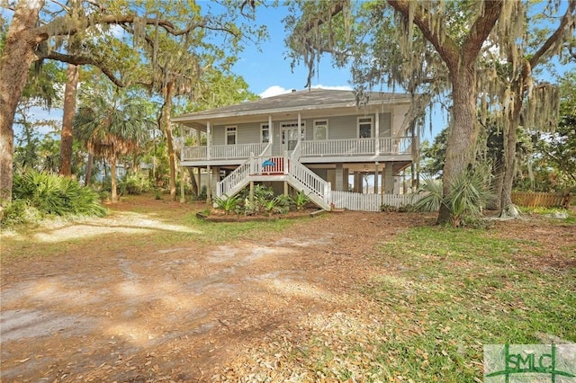 back of property featuring a porch and stairway