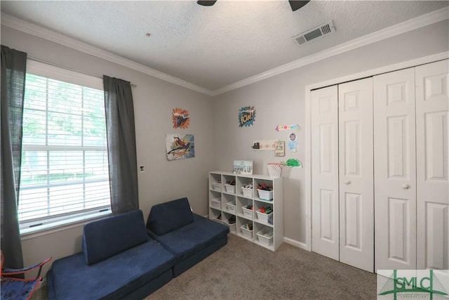 living area featuring a textured ceiling, visible vents, and a healthy amount of sunlight