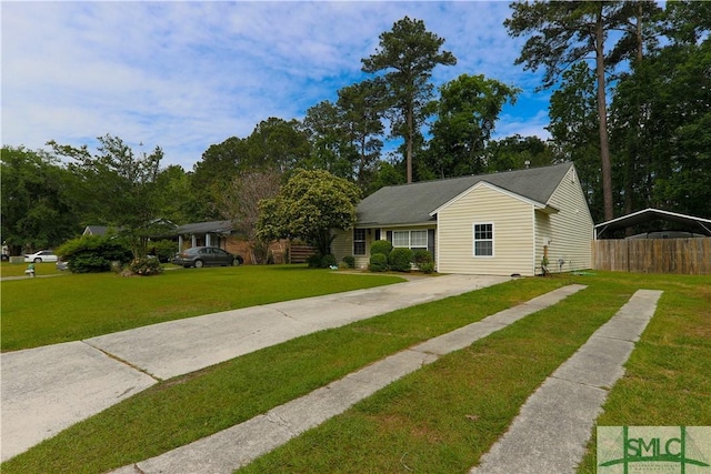 bungalow-style home featuring fence, driveway, a front yard, and a carport