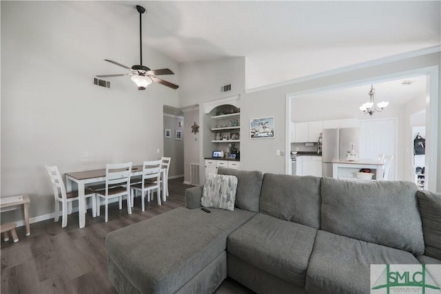 living area featuring built in shelves, baseboards, wood finished floors, and visible vents