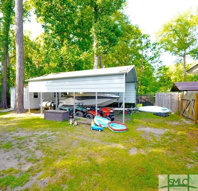 368 Piercefield Dr, Richmond Hill, GA 31324 - view of vehicle parking with a detached carport and fence