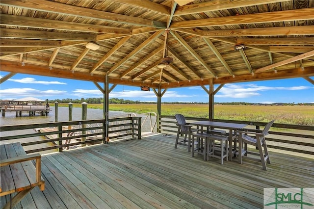 view of dock featuring a water view and outdoor dining space