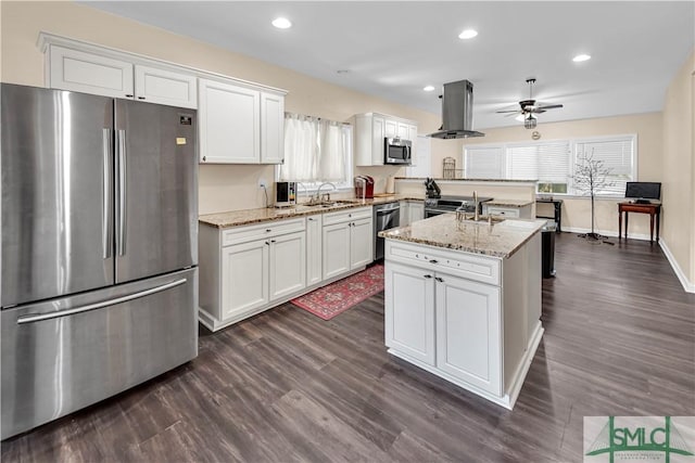 2115 Gable St, Savannah, GA 31404 - kitchen with ceiling fan, dark wood-style floors, island range hood, white cabinetry, and stainless steel appliances