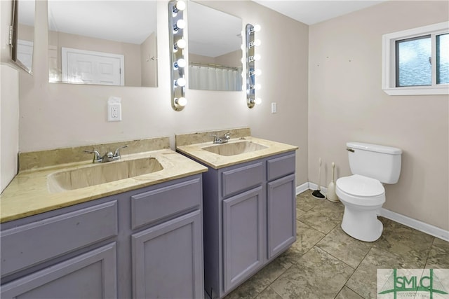 2115 Gable St, Savannah, GA 31404 - full bathroom with toilet, baseboards, two vanities, and a sink
