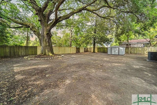 2115 Gable St, Savannah, GA 31404 - view of yard with a storage shed, an outdoor structure, a fenced backyard, and central air condition unit