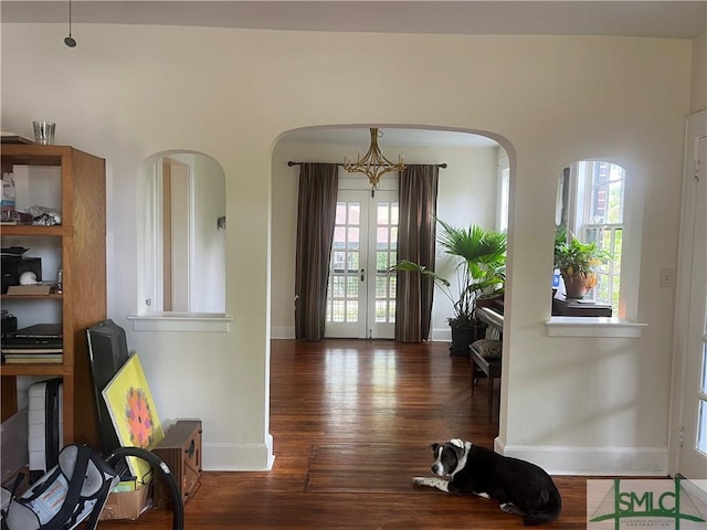 1901 E Anderson St E, Savannah, GA 31404 - dining room featuring arched walkways, baseboards, plenty of natural light, and wood finished floors