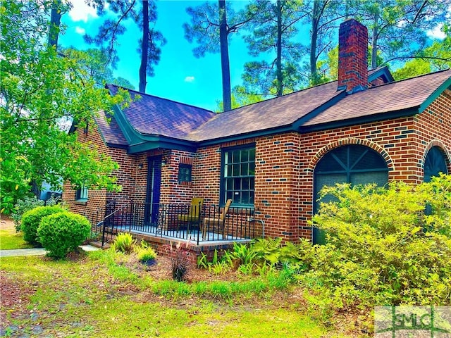 1901 E Anderson St E, Savannah, GA 31404 - view of front of property with brick siding, a chimney, and roof with shingles