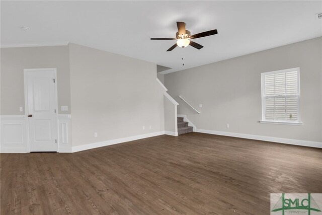 unfurnished living room featuring a ceiling fan, visible vents, stairway, and dark wood-type flooring