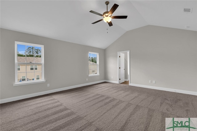 carpeted empty room featuring ceiling fan, visible vents, baseboards, and lofted ceiling