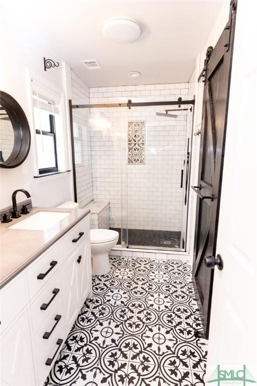 204 Archibald St, Rincon, GA 31326 - full bathroom with vanity, toilet, a shower stall, and tile patterned flooring