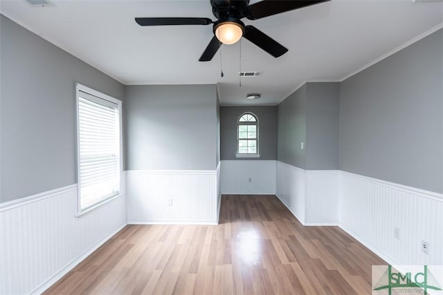 204 Archibald St, Rincon, GA 31326 - empty room with wainscoting, wood finished floors, and a ceiling fan